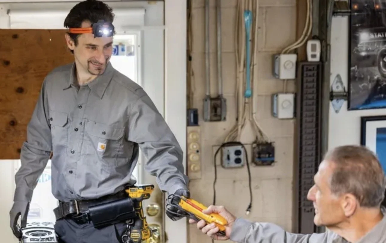 Mr. Speedy Electric technicians testing a circuit with a multimeter